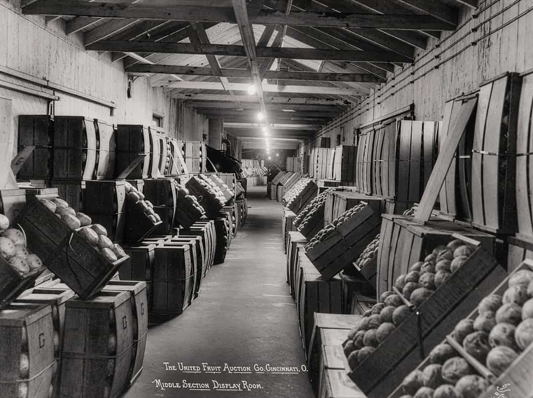 a black and white photo of crates of produce